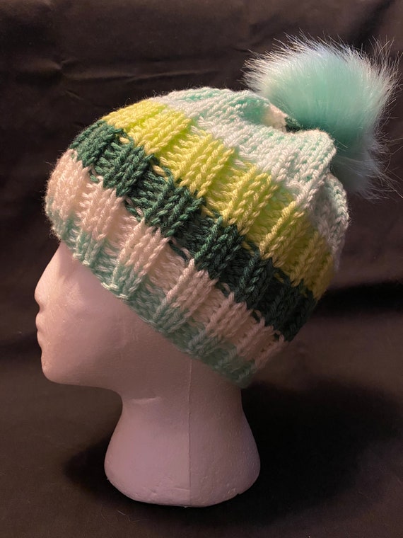 Hand knit green and teal beanie with faux fur pom pom