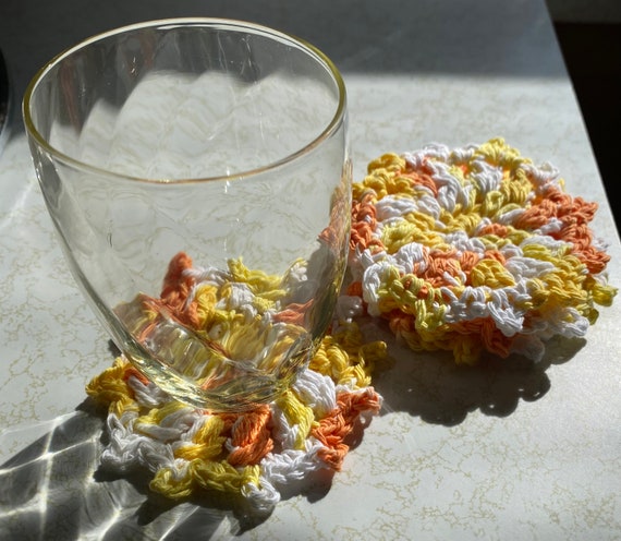 set of 4 hand crocheted cotton coasters in sunshine yellow orange and white