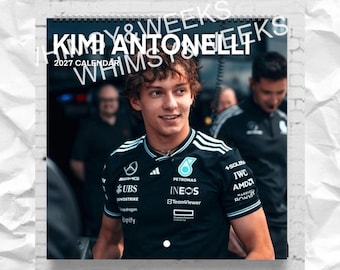 May include: A 2027 wall calendar featuring a photograph of Kimi Antonelli wearing a black Mercedes-AMG Petronas Formula One team shirt with white sponsor logos, including Petronas, IWC, and TeamViewer, against a blurred garage background.