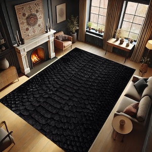 May include: Black and white snakeskin patterned rug with a textured surface. The rug is laid out on a wooden floor in a living room setting.