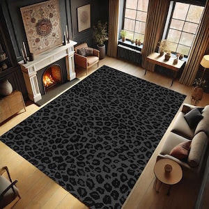 May include: A large, rectangular area rug with a black leopard print pattern. The rug covers a significant portion of a room with hardwood flooring. The room features a fireplace, windows, and furniture.