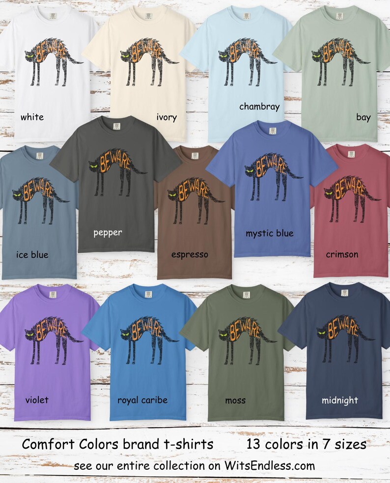 May include: A collection of Comfort Colors brand t-shirts in various colors, each featuring a black cat design with the word "BEWARE" in orange. The shirts are available in 13 colors and 7 sizes.