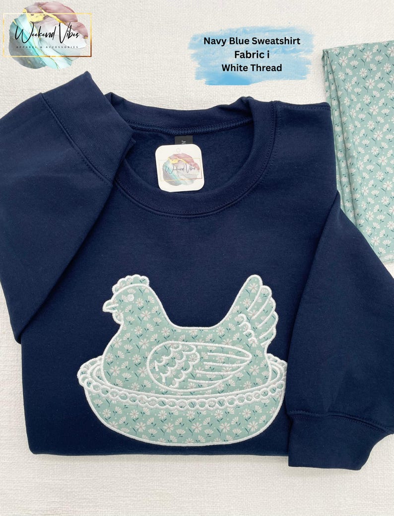 Embroidered Hen on Nest using fabric option I (i as in igloo) on a Navy sweatshirt.