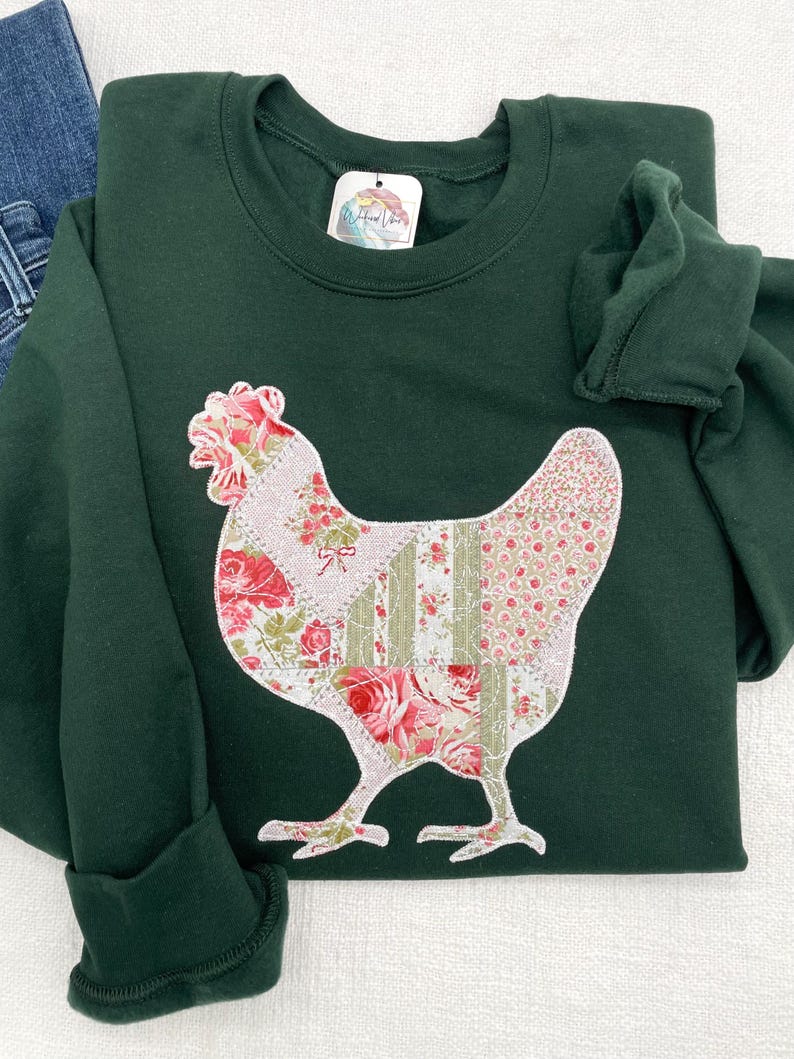 Embroidered chicken on a green sweatshirt. Fabric is a printed patchwork design with shades of pink florals and sage.