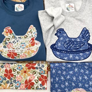 Two Hen on Nest sweatshirts laying on a grass basket with Fabric D and C placed under appliqued nesting chicken.