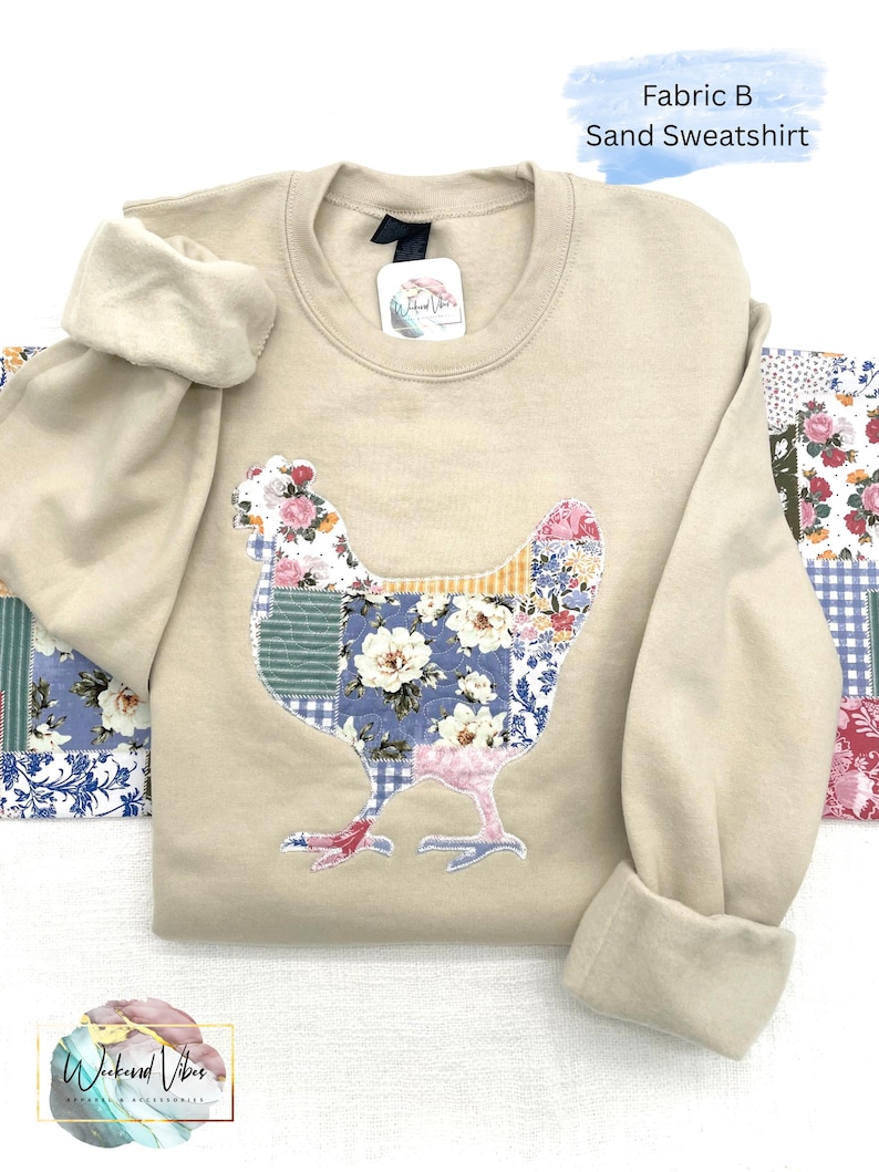 Quilt like printed fabric appliqued on a sand colored Gildan sweatshirt. Sweatshirt has sleeves rolled and is on the applique fabric.