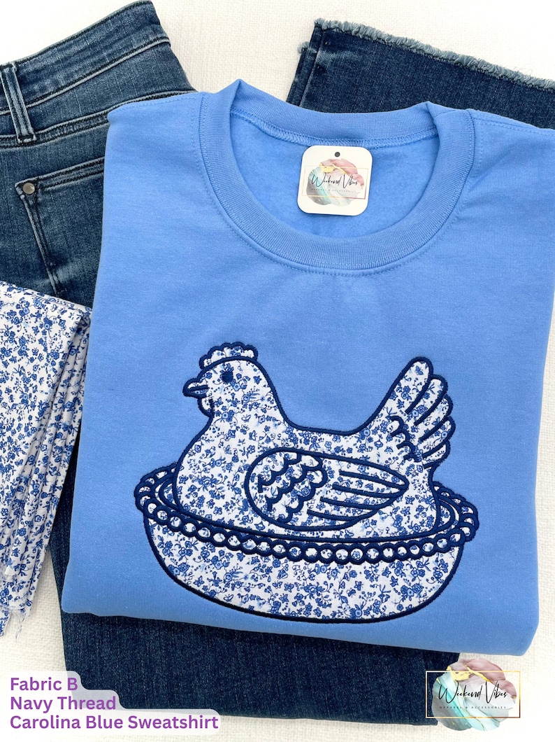 Embroidered Hen on Nest sweatshirt using Fabric B, Carolina Blue sweatshirt, and navy thread.