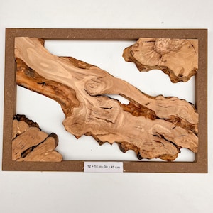 May include: A rectangular wall art piece featuring natural light brown wood slabs with organic edges set within a dark brown frame. A white label at the bottom centre displays the text 12 x 18 in - 30 x 45 cm, indicating the dimensions.