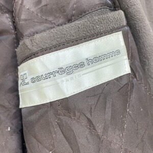 May include: A white label with the text "courr&egrave;ges homme PARIS" in black lettering.