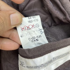 May include: Brown jacket with a white label that says "courreges homme" and a smaller white label with the text "84-92 160-170 C-OS-546 日本製".