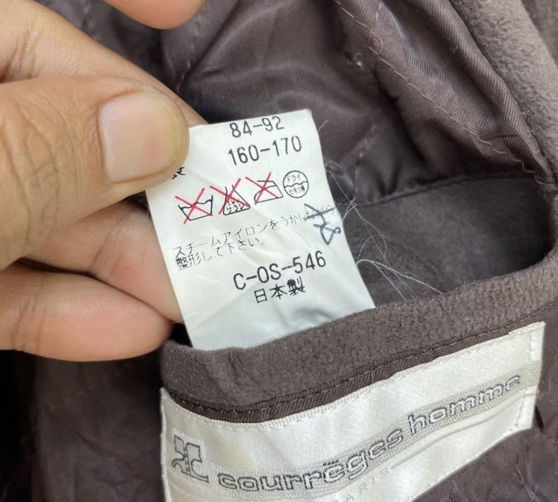 May include: Brown jacket with a white label that says "courreges homme" and a smaller white label with the text "84-92 160-170 C-OS-546 日本製".