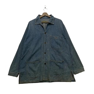 May include: A blue denim jacket with a button-up front, a collared neckline, and three front pockets. The jacket has long sleeves and is hanging on a wooden hanger. The jacket is a medium wash denim.