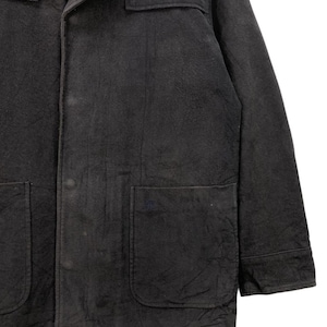 May include: A dark gray corduroy jacket with a button-up front, two flap pockets, and a single pocket on the left chest. The jacket has a collar and long sleeves.