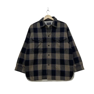 May include: A brown and black checked flannel shirt with a button-up front and long sleeves.