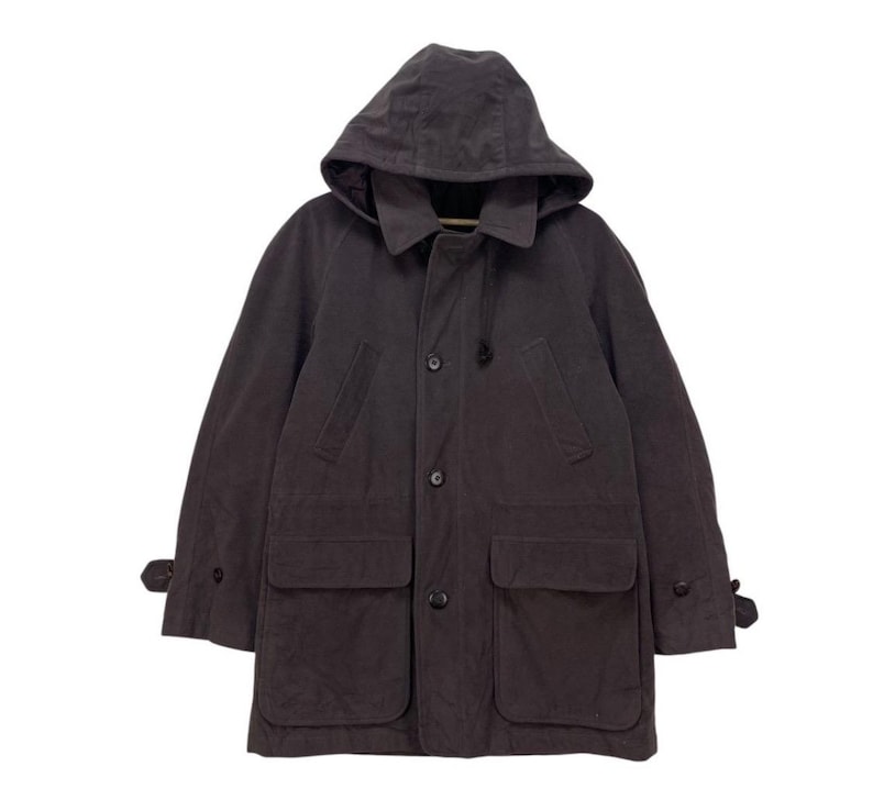 May include: A dark gray hooded jacket with a button closure, two large pockets, and a drawstring hood.