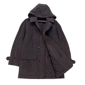 May include: A dark brown hooded jacket with a button closure and a large pocket on the front. The jacket has a zippered inner lining and a drawstring hood.