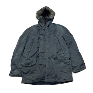 Könnte beinhalten: Vintage, dunkel petrolfarbener Parka mit Kunstfell gefütterter Kapuze. Die Jacke hat mehrere Taschen, eine Knopfleiste und einen Reißverschluss. Der Parka ist ein strapazierfähiger Mantel für kaltes Wetter.