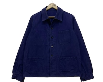 May include: A dark blue work jacket with multiple pockets and a button-up front.