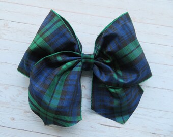 May include: A large blue and green plaid bow. The bow is made of a satin-like fabric and has a slightly shiny finish.