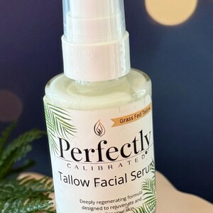 May include: A clear glass bottle of Perfectly Calibrated Tallow Facial Serum with a white pump top. The label includes text and a palm frond design. The words "Grass Fed Tallow" are also visible.