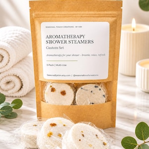 May include: A brown paper pouch containing aromatherapy shower steamers with a label reading SEASONAL TOUCH CREATIONS BY KIM, AROMATHERAPY SHOWER STEAMERS, Custom Set, Aromatherapy for your shower - breathe, relax, refresh, 3-Pack | Multi-Use.
