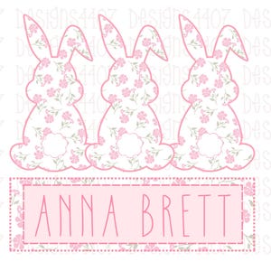 May include: Three pink bunny silhouettes with floral patterns, arranged in a row. A pink banner with the text "ANNA BRETT" is below the bunnies.