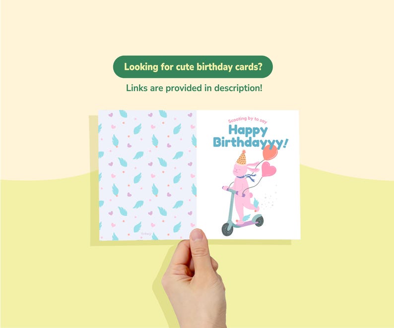 May include: A birthday card held by a hand, featuring a pink bunny on a scooter with balloons and the text "Happy Birthdayyy!". The card's interior has a pattern of blue feathers and pink hearts. The text "Looking for cute birthday cards? Links are provided in description!" is also visible.