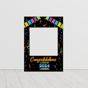 May include: Black photo booth frame with colourful confetti and streamers. The frame has a white square in the centre for a photo. The text "Congratulations Class of 2024 Leavers" is at the bottom of the frame.