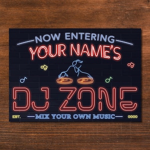 May include: A neon sign with the words "NOW ENTERING YOUR NAME'S DJ ZONE" in red and blue. The sign features a DJ graphic and musical notes on a black brick background. The sign reads "MIX YOUR OWN MUSIC".