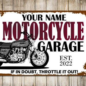 May include: A white metal sign with brown edges featuring a black and white illustration of a motorcycle. The sign reads "YOUR NAME MOTORCYCLE GARAGE EST. 2022 IF IN DOUBT, THROTTLE IT OUT!"