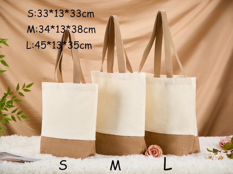 May include: Three canvas tote bags in varying sizes, with beige handles and a natural-colored bottom. The sizes are labeled S, M, and L, with dimensions of 33x13x33cm, 34x13x38cm, and 45x13x35cm respectively. The bags are displayed on a white surface.
