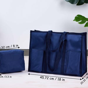 May include: Navy blue tote bag and matching pouch. The tote bag is 18 inches wide, 13 inches tall, and 8 inches deep, with two exterior pockets. The pouch is 6.5 inches tall, 3.3 inches wide, and 8 inches deep. Both have handles.