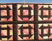 Churn Dash Block Quilt with hand dyed cotton Kona fabric, black sashing and black back, measures 43 by 49 inches