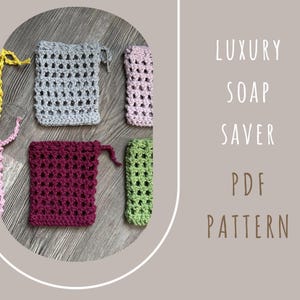 May include: A collection of handmade crochet soap savers in various colors, including gray, pink, green, and burgundy. The image also includes the text "LUXURY SOAP SAVER PDF PATTERN". These reusable soap bags are designed to extend the life of your soap.