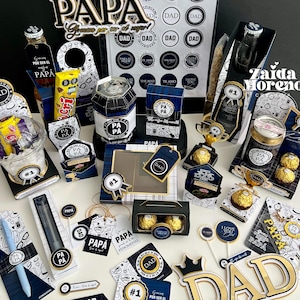 May include: A collection of gift items with a Father's Day theme. The items include decorative boxes, candy, pens, and small bottles, all in a color scheme of black, white, and gold. The word "DAD" is prominently displayed on several items.