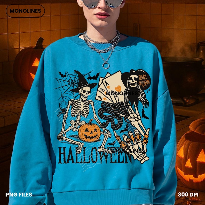 May include: A turquoise blue Halloween-themed sweatshirt with a graphic design featuring skeletons, playing cards, bats, and a pumpkin. The word "HALLOWEEN" is printed in bold letters at the bottom of the design. The brand name "MONOLINES" is at the top.