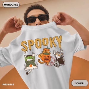 Vintage style spooky cat artwork with three adorable Halloween cats in colorful costumes designed for t shirts mugs tote bags and printable crafts.