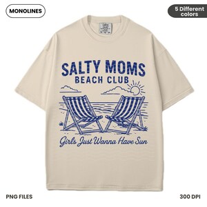 May include: A beige t-shirt with a blue graphic design that says "Salty Moms Beach Club" with two beach chairs and a sun. The text below the graphic says "Girls Just Wanna Have Sun".