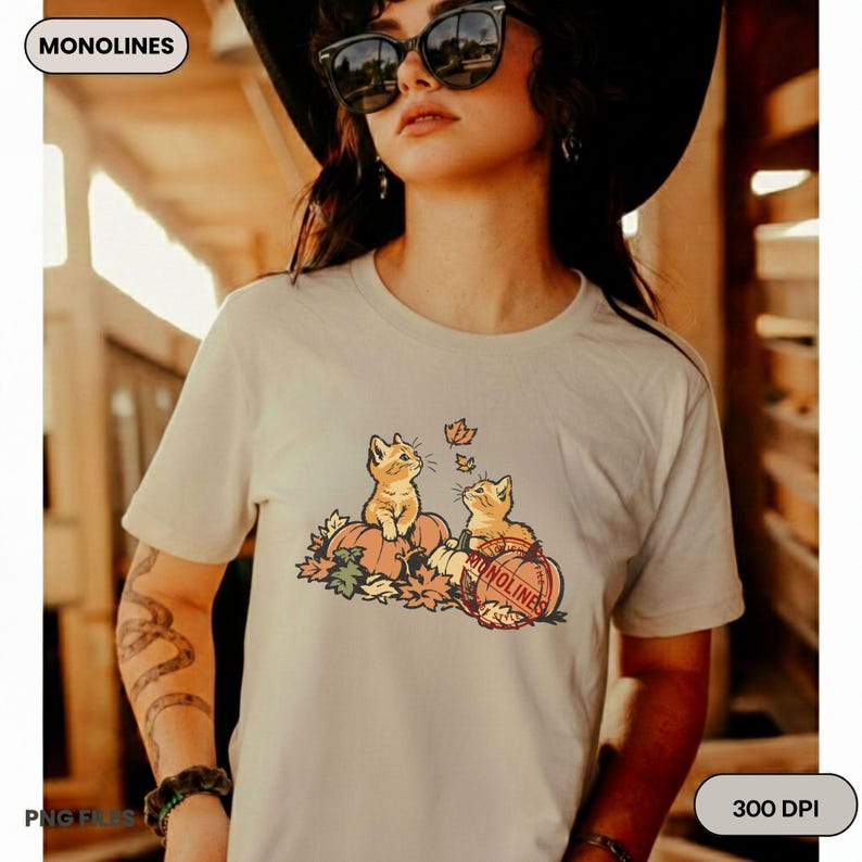 Fall Cat PNG featuring two playful kittens on pumpkins with falling maple leaves for cozy autumn shirt designs and DIY projects.