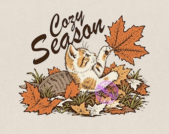 May include: A digital illustration of a tabby kitten lying in a pile of fallen autumn leaves, reaching up to touch a large maple leaf. The text Cozy Season is written in a dark brown script above the kitten. A purple circular watermark is visible.
