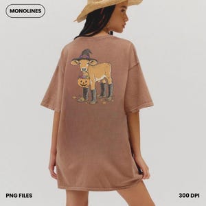 May include: A brown short-sleeve t-shirt featuring a graphic on the back of a calf wearing a witch hat and black boots, holding a jack-o'-lantern bucket filled with candy. The text MONOLINES, PNG FILES, and 300 DPI are visible in the corners.