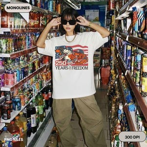 May include: A white t-shirt with a graphic of two cartoon bears and an American flag, with the text "250 YEARS of FREEDOM". The person is wearing sunglasses and khaki trousers, standing in a shop aisle.