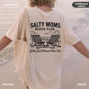 May include: A white t-shirt with a black graphic design that says "Salty Moms Beach Club" with two beach chairs and a sun. The text below the graphic says "Girls Just Wanna Have Sun".