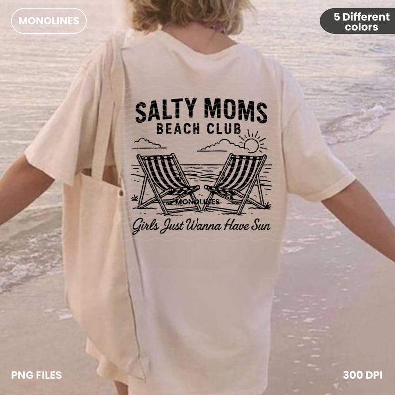 May include: A white t-shirt with a black graphic design that says "Salty Moms Beach Club" with two beach chairs and a sun. The text below the graphic says "Girls Just Wanna Have Sun".