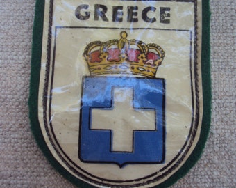 Parche de viaje vintage de Grecia en forma de escudo, de fieltro y recubierto de plástico.