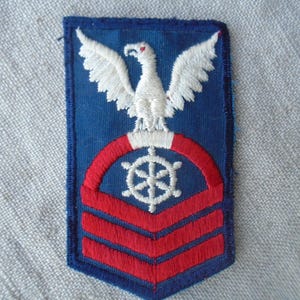 May include: A set of three ceramic mugs with a speckled, matte finish. The mugs are in shades of cream, light gray, and dark gray. Each mug has a simple, minimalist design, perfect for coffee or tea.