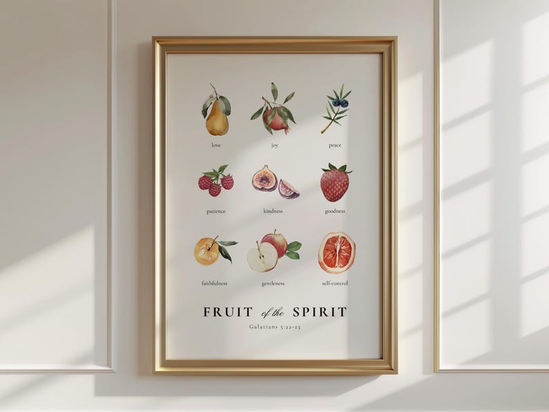 May include: A framed print with a white background and gold frame. The print features a watercolour illustration of different fruits with the text "FRUIT of the SPIRIT Galatians 5:22-23" at the bottom.