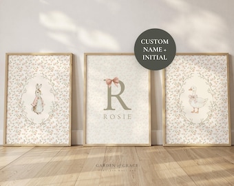 May include: Three framed nursery art prints. One features a bunny, another a duck, and the center print has a letter "R" and the name "Rosie". All prints have a floral background and are in wooden frames.