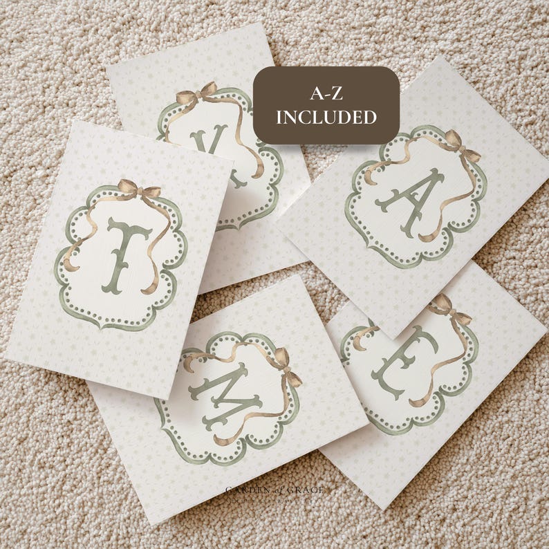 May include: A collection of decorative cards with letters A, E, F, M, and V. Each card features a letter in a sage green color, framed by a decorative border and a bow. The cards are on a light beige background with small white dots. Text on the image reads "A-Z INCLUDED."