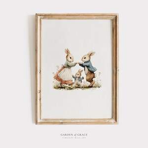May include: A framed watercolor print featuring three anthropomorphic rabbits in a field of wildflowers. The rabbits are dressed in vintage clothing, with the parents holding hands and the child rabbit standing in front.